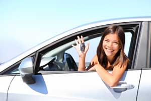 Girl in car window holding keys